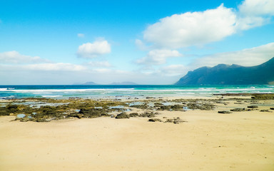 Fototapeta na wymiar Beach and mountains - beautiful coast in Caleta de Famara, Lanzarote Canary Islands.