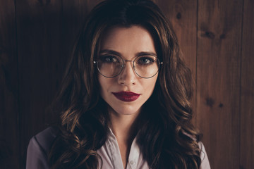 Close-up cropped portrait of cute lovely sweet adorable magnificent glamorous attractive wavy-haired lady sales manager marketer designer company founder director workplace station over wooden wall