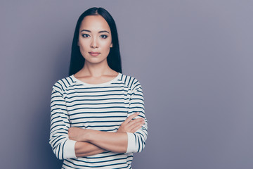 Obraz premium Close up portrait of attractive amazing brunette she her holding hands crossed looking without smiling self-confident wearing white pullover isolated on grey background
