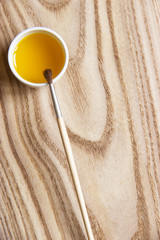 treatment of wood with impregnation for protection. linseed oil on the board with a brush. wooden...