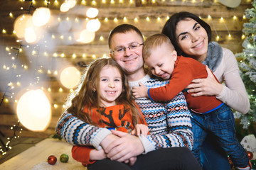 Obraz na płótnie Canvas happy hugging family in christmas house