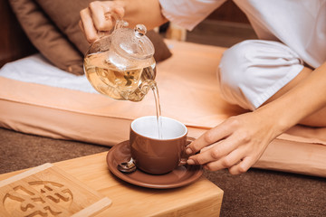 Close up of green tea being poured in the cup