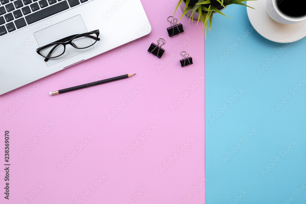 Poster flat lay of top view modern desk blue&pink pastel color tone work table with computer laptop and sta