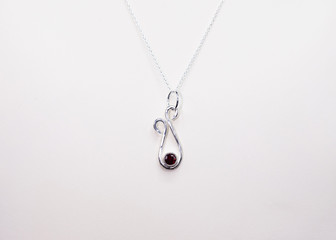 hand crafted sterling silver pendant with a red gem stone