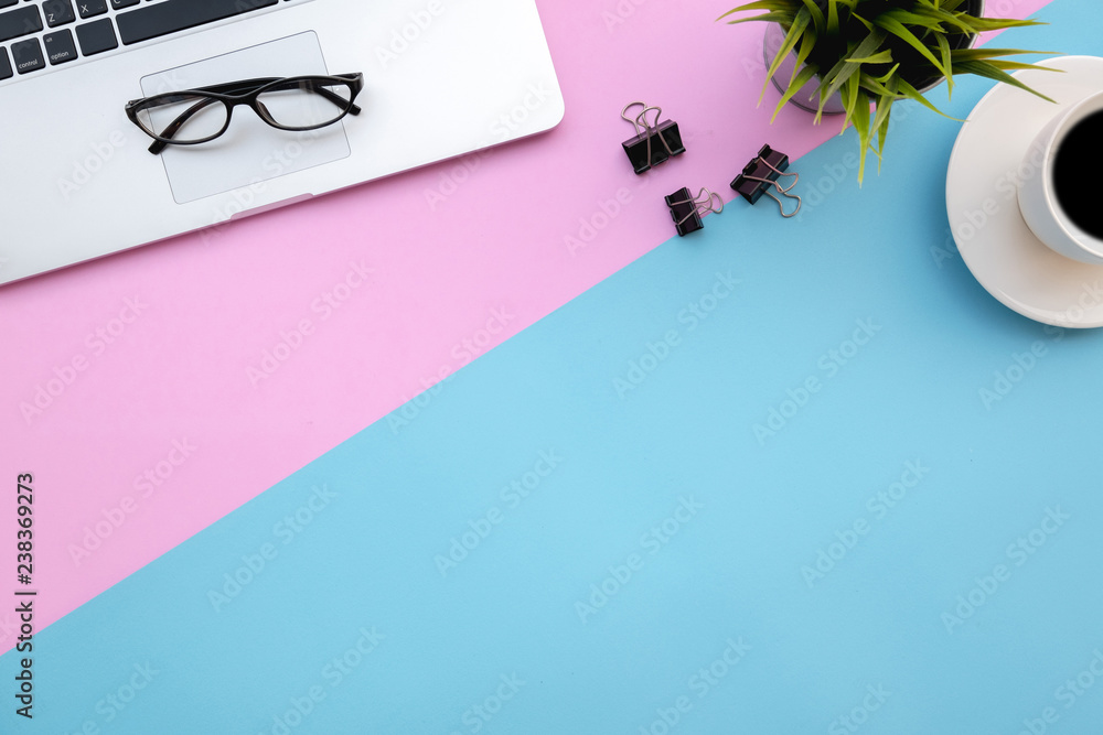 Poster flat lay of top view modern desk blue&pink pastel color tone work table with computer laptop and sta