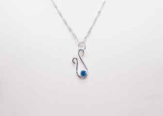 hand crafted sterling silver pendant with a blue gem stone