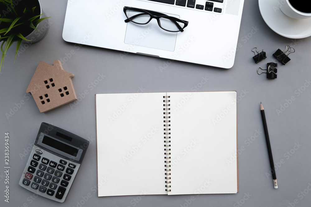 Poster flat lay of top view modern grey desk work table with computer laptop and stationary in home office 