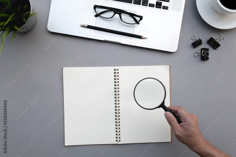 Poster flat lay of top view modern grey desk work table with computer laptop and stationary in home office 