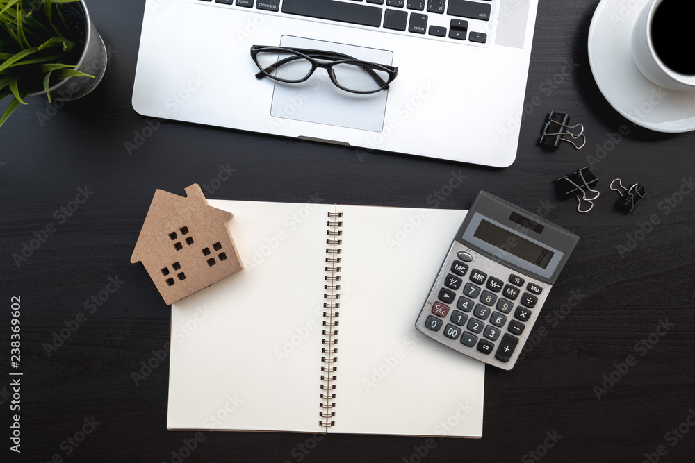 Poster flat lay of top view modern black wood desk work table with computer laptop and home property analys