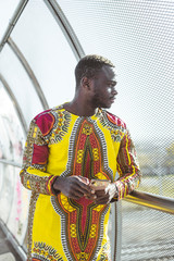 African businessman with smartphone and the clothes of typical