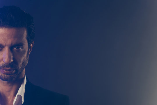 Cropped close-up half-faced portrait of nice chic classy elegant attractive handsome confident content man in black jacket copy empty blank space isolated over dark grey blue fume smoke background - Powered by Adobe