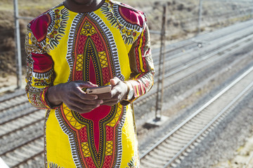 African businessman with smartphone and the clothes of typical