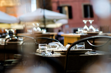 Served tables on the summer terrace of the restaurant in Nettuno. Italy.