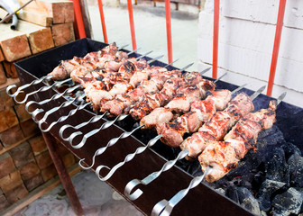 pieces of meat on skewers fried on the grill