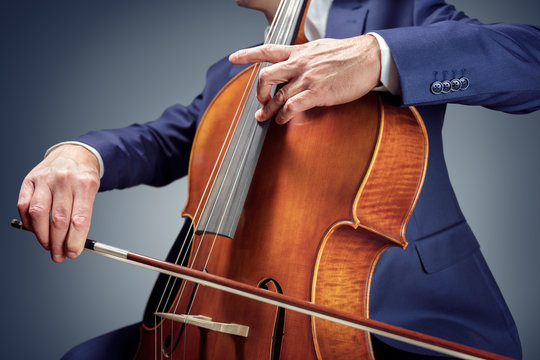 Cellist  or cello player performing