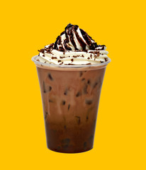 Frappuccino with ice in takeaway cup on yellow background 