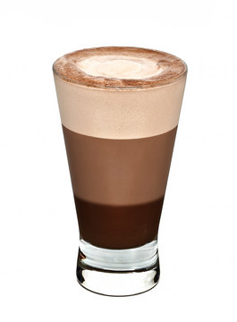 Layered coffee in tall glass isolated on white background