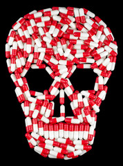 Drug capsules, skull of pills red and white on a black background. Overdose. Drug abuse concept.