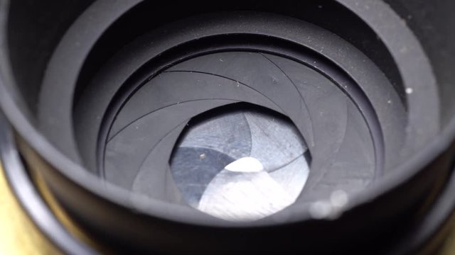 Aperture or iris mechanism in rotation. Camera lens aperture close up. Concept of photo, video job.