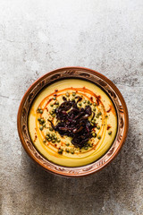 Authentic Greek Fava recipe, Middle Eastern yellow lentil soup with caramelized onions, paprika and capers. vegan healthy food in clay pots on the stone table