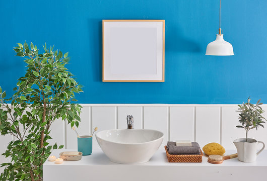 Bath room blue and white background, frame white lamp and sink detail. © UnitedPhotoStudio