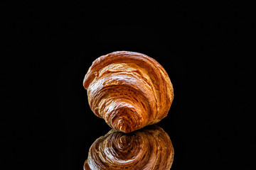 Сroissants of puff pastry on a black background