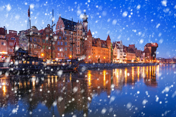 Fototapeta premium Old town of Gdansk on a cold winter night with falling snow, Poland