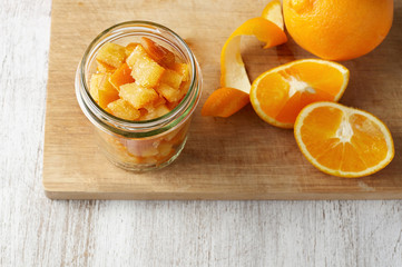 Pieces of candied orange peel coated in sugar in jar