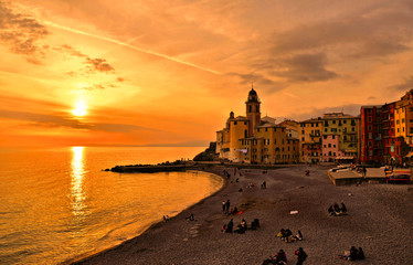  Panoramic view of historical Old Town Camogli and sand beach with people on sunset in mediterranean coast in Camogli, italian Riviera, Italy