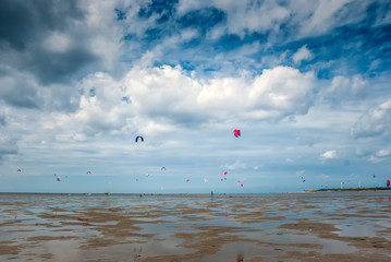 people kite surfing on the beach