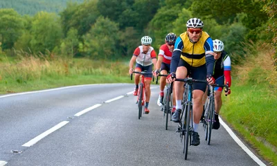 Foto op Aluminium A group of cyclists on a bike race on a country roads in the UK. © Duncan Andison
