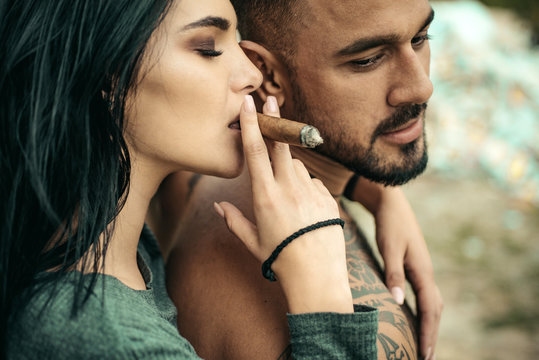 Cuban cigar. Sensual latino mulatto couple. Latin men enjoing and relaxing with love women. Couple enjoy in the moment. Latin women smoking cuban cigar. Sensual couple in love.