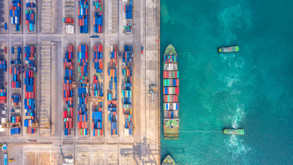 Container ship in export and import business and logistics. Shipping cargo to harbor by crane....