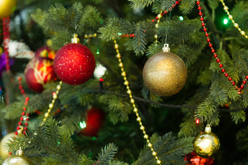 Obraz na płótnie Canvas Christmas toys hanging on the Christmas tree