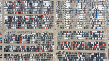 Cars export terminal in export and import business and logistics. Shipping cargo to harbor. Water transport International. Aerial view and top view.