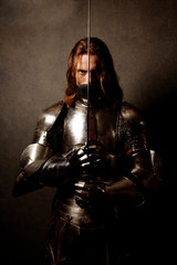 Portrait of a knight in armor on guard - obrazy, fototapety, plakaty