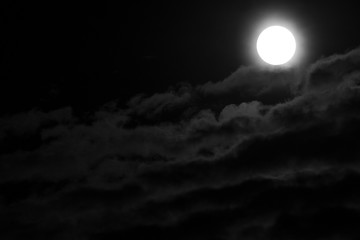 Full Moon and clouds on the night sky