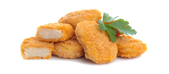 a heap of chicken nuggets with a parsley leaf on a white isolated background