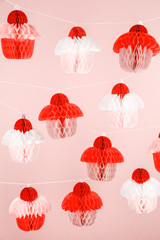 Obraz premium Paper cupcakes celebration decoration. Holiday party concept . Living coral theme - color of the year 2019
