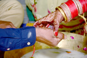 Indian couple playing Ring Fishing game in wedding ceremony of India