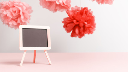 Empty small charcoal board at the girl baby shower party.  Baby shower celebration concept . Living coral theme - color of the year 2019