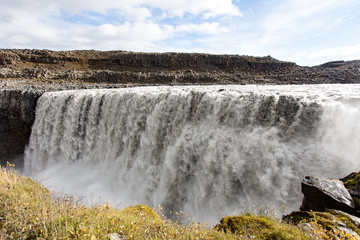 Dettifoss is the most powerful waterfall in Europe. Huge streams of water falling down from a cliff. Yokulsarglufur National Park, Iceland.