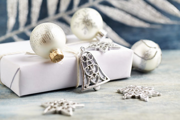 Christmas decoration and present. Christmas bell and silver baubles.  Christmas time. Wooden background. Close up.