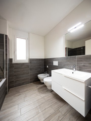 Fototapeta na wymiar Bathroom with elegant minimalist brown tiles