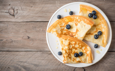 Crepes with blueberries and honey