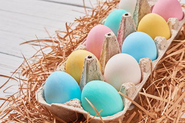 Colorful easter eggs in a paper tray close up