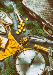LATIN AMERICAN AND SPANISH NEW YEAR TRADITIONS. empty suitcase, lentil spoon, yellow interior clothes, gold ring in champagne, 12 grapes, money in shoe. Christmas background