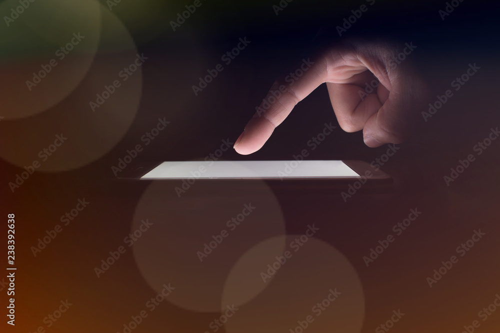 Poster close up image of a business man using technology on a phone in a dark room. concept technology.