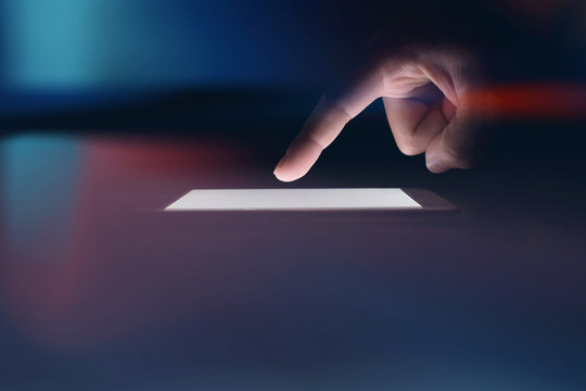 Image Businessman is using technology on a phone in a dark room. - Powered by Adobe