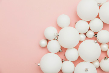 Christmas winter composition. White christmas balls on a pastel pink background
